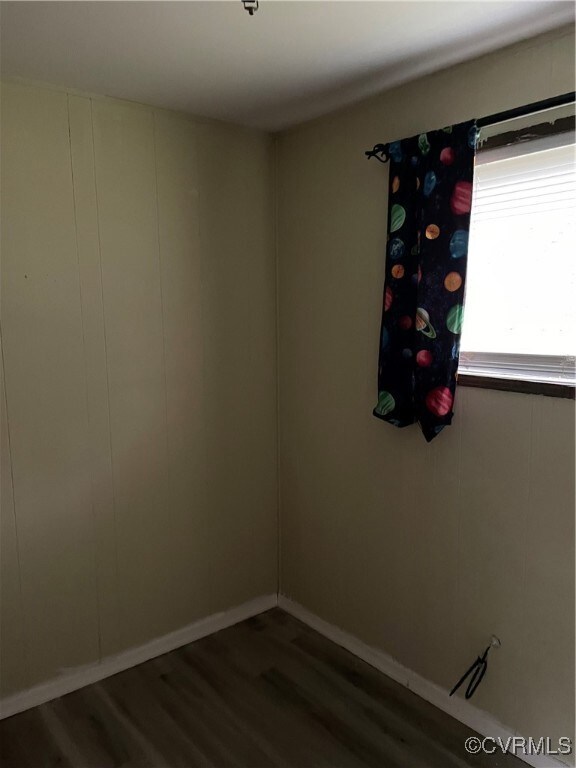 Empty room featuring wood finished floors