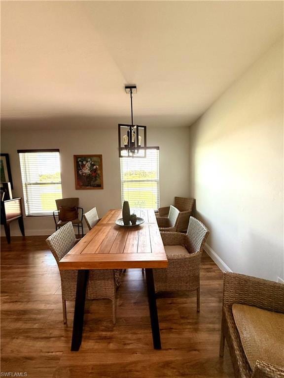 Stylish dining area featuring light wood-style floors, seamlessly integrated into the great room with open views of the kitchen, living space, and warm, welcoming foyer—ideal for both casual meals and elegant entertaining.