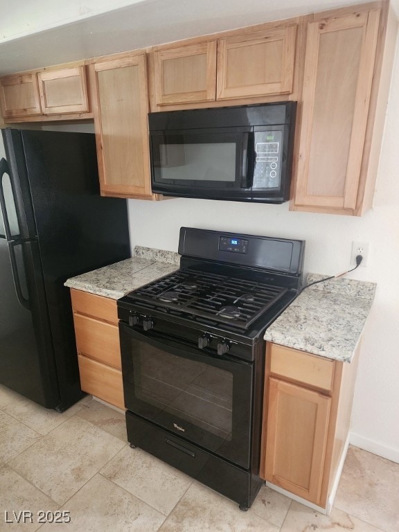 Kitchen with black appliances, light brown cabinet