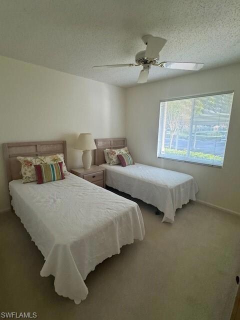 Bedroom featuring carpet floors, a textured ceilin