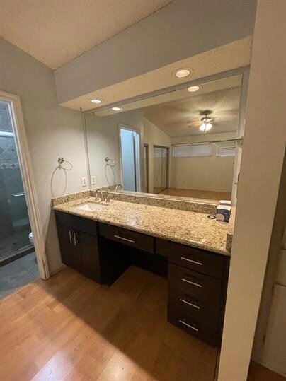 Full bath featuring wood finished floors, vanity,