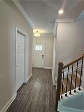 Corridor featuring baseboards, ornamental molding, wood finished floors, and recessed lighting