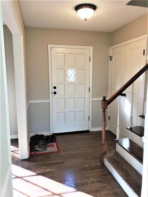 Hardwood entry and hardwood stairs to the bedroom 