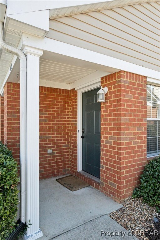 Property entrance with brick siding