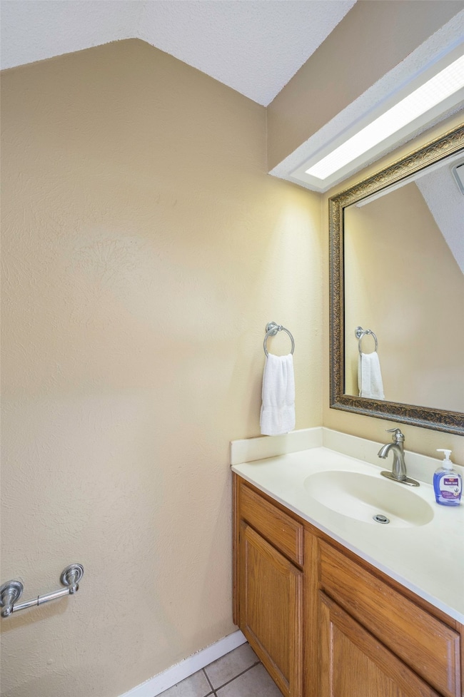 Bathroom with vanity and light tile patterned floors