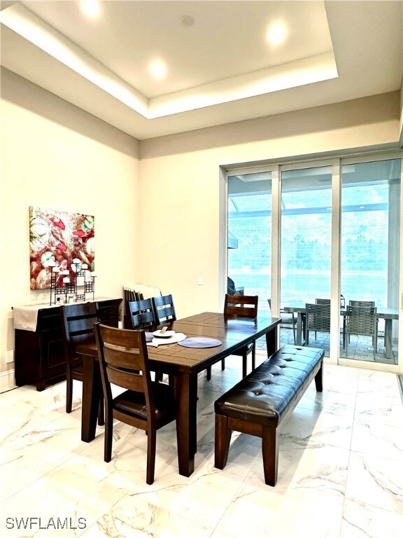 Dining room with a raised ceiling