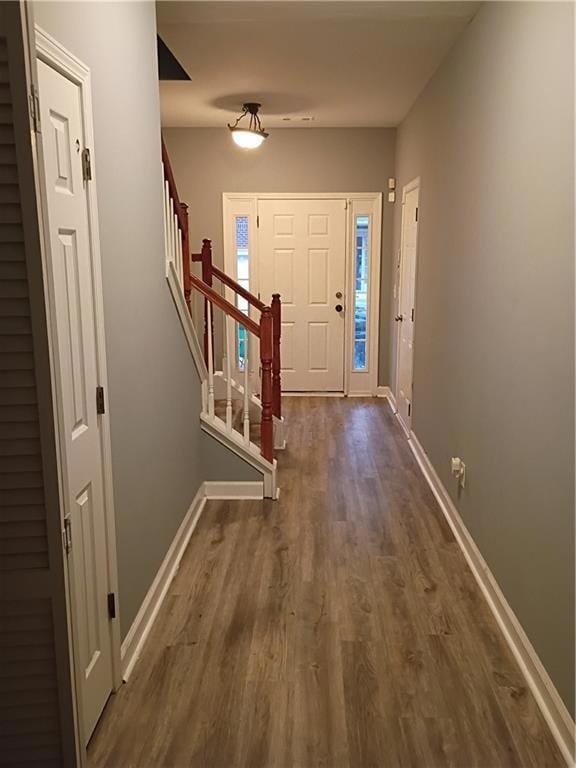 Entrance foyer featuring stairway and dark wood finished floors