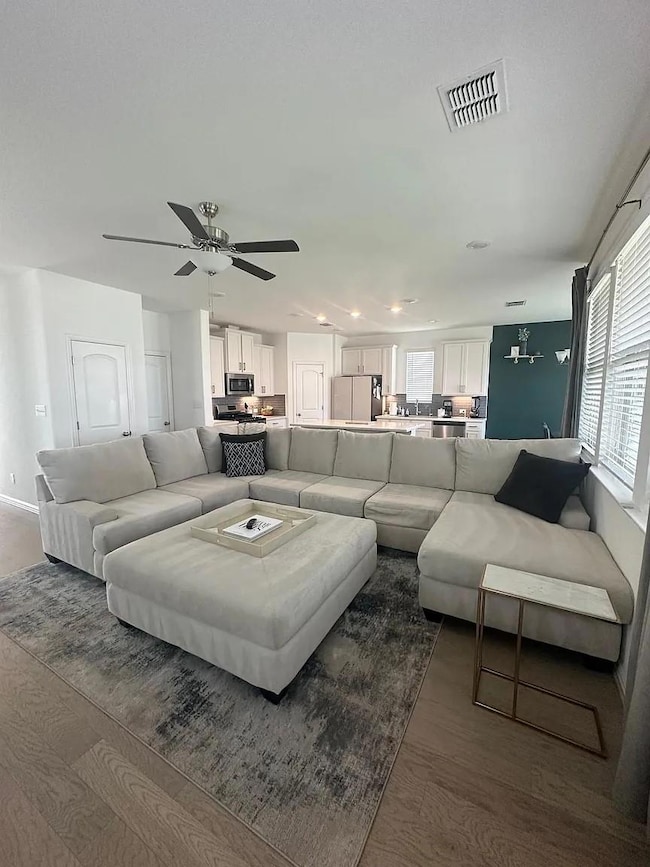 Living room with visible vents, wood finished flo