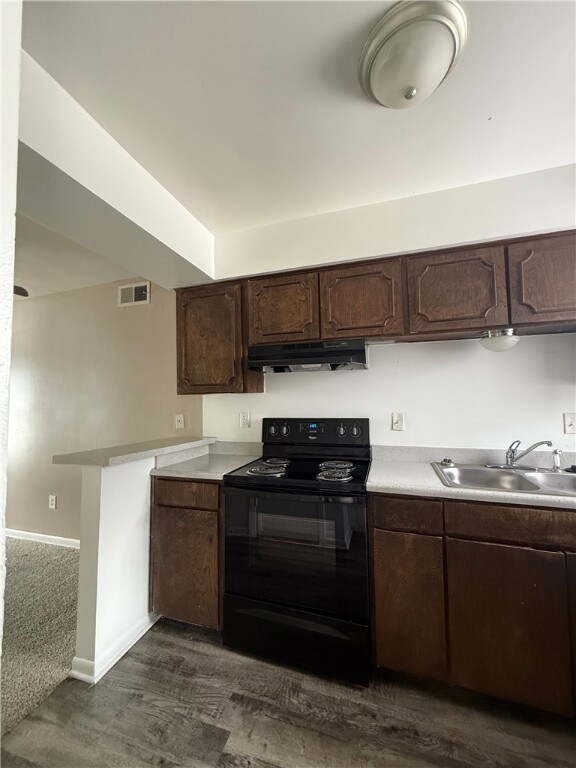 Kitchen with electric range, under cabinet range h