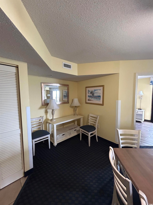 Bedroom featuring a textured ceiling and a closet