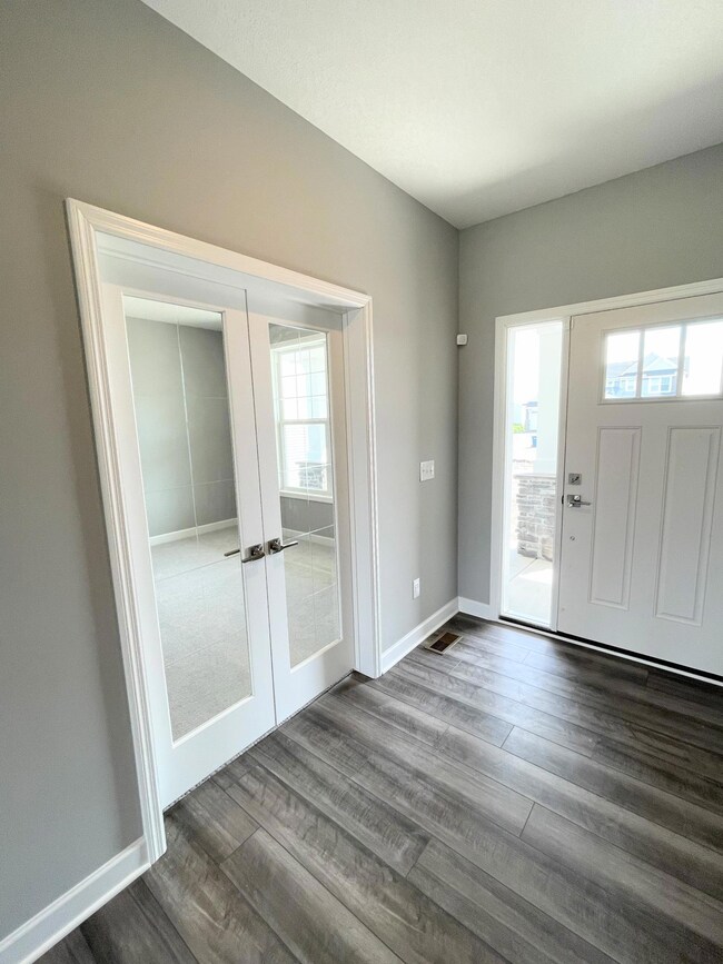 Photos is of a different, sold home. The natural light streams through the tempered glass doors.