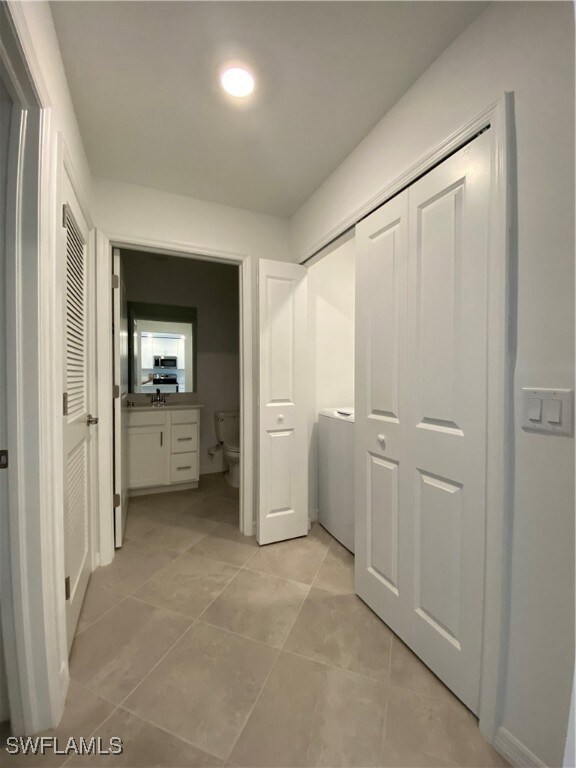 Corridor with light tile patterned floors