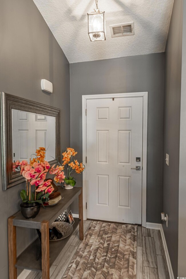Entrance foyer with hardwood / wood-style flooring