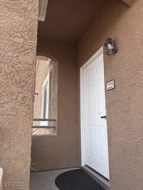 Property entrance with stucco siding