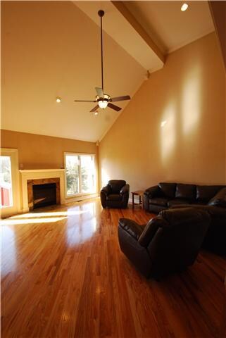 Family room offers a gas fireplace with granite surround, vaulted ceilings with recessed lighting and fan.