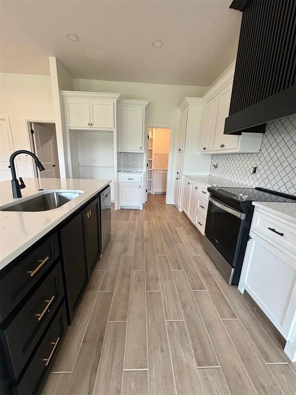 Kitchen featuring stainless steel appliances, back