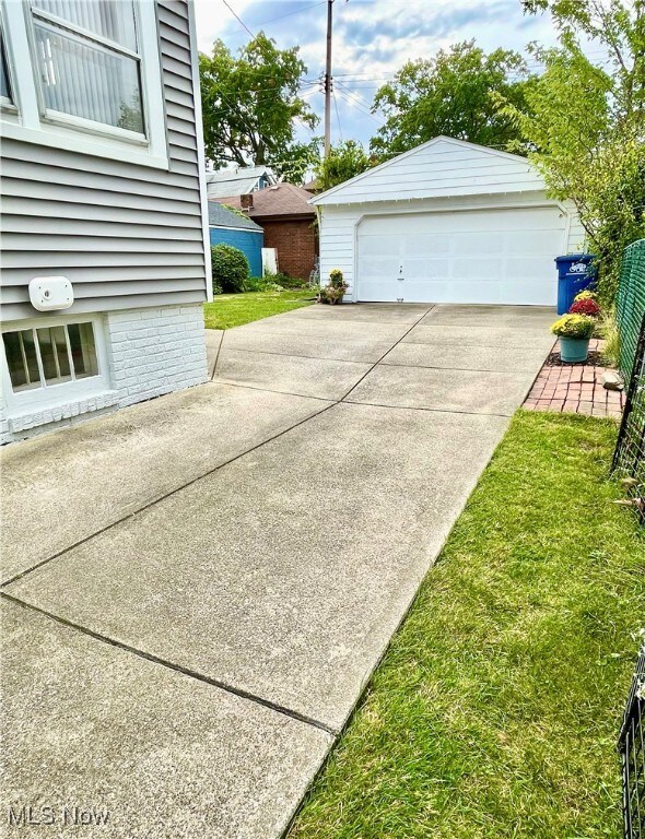Two car Garage with new roof featuring extra concrete space