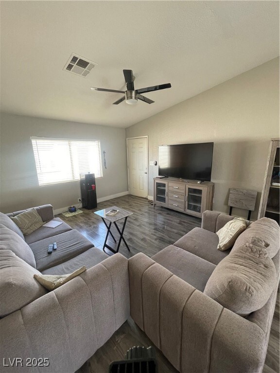 Living area featuring visible vents, baseboards, d