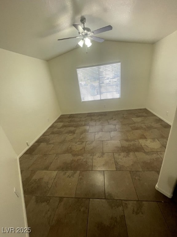 Spare room featuring baseboards, ceiling fan, and