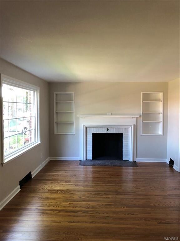 Living room with beautiful picture window and buil