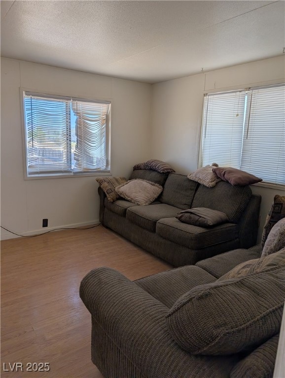 Living room with wood finished floors and baseboar