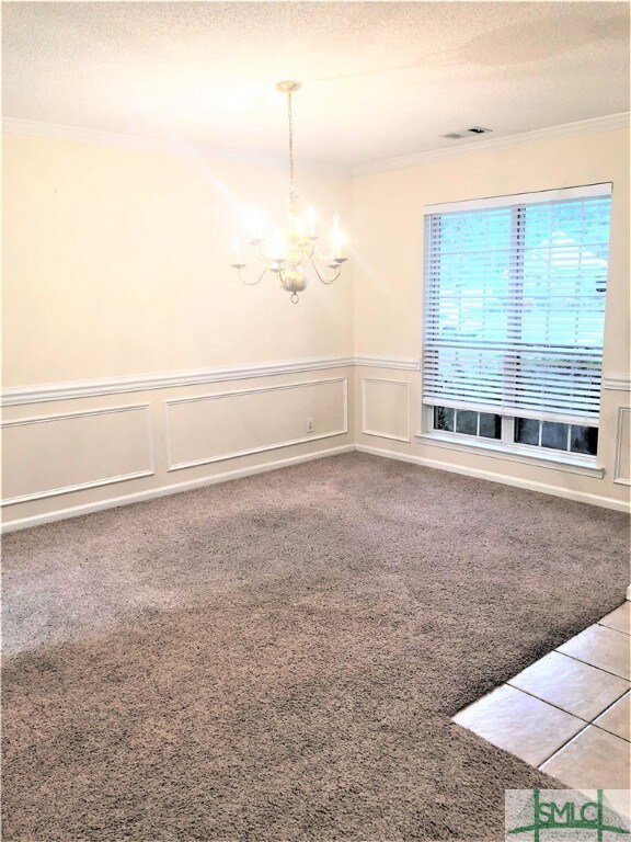 Spacious formal dining room with large window that
