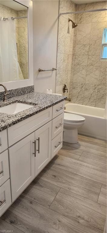 Full bathroom with shower / bath combo, toilet, an