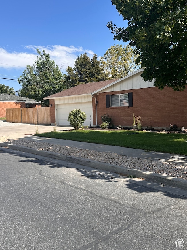 View of front of house featuring brick siding, a garage, and concrete driveway
