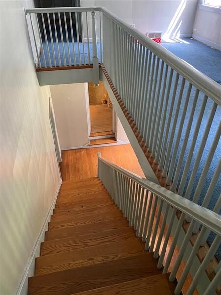 Grand entry and stairwell with hardwood floors