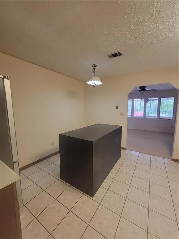 Kitchen featuring a ceiling fan, light tile patter