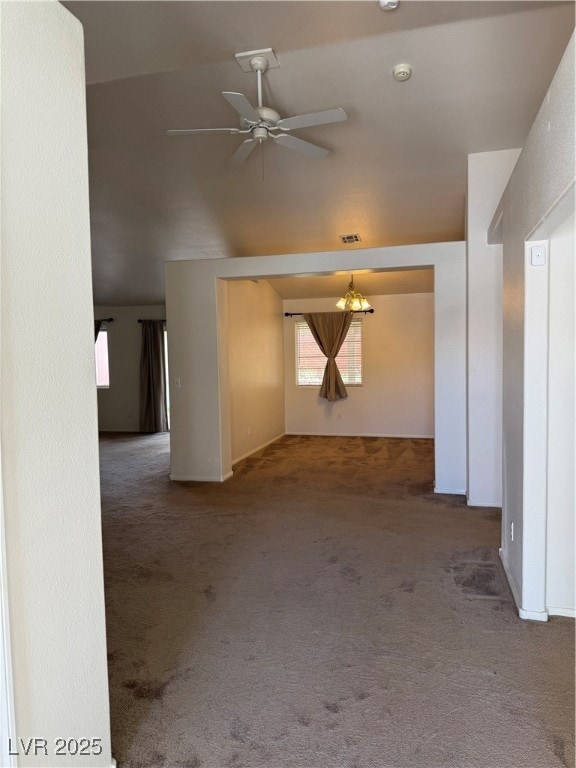 Unfurnished living room featuring vaulted ceiling,