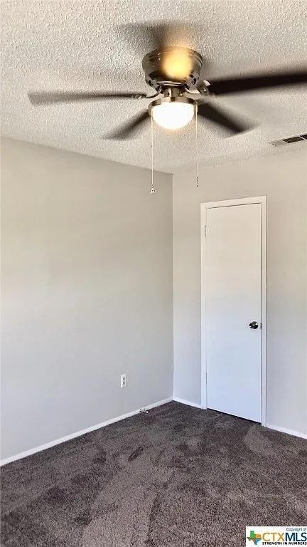Empty room featuring a ceiling fan, carpet floors