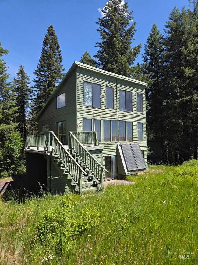 Front of property with stairway and a deck