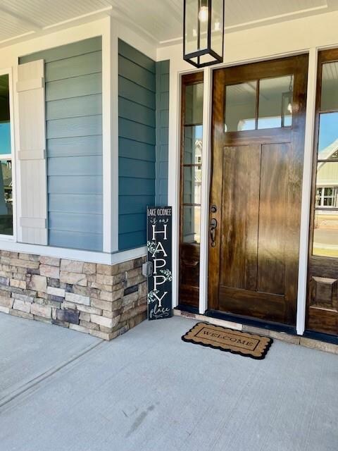 View of exterior entry featuring covered porch