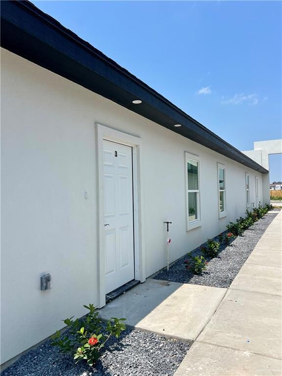 Property entrance with stucco siding