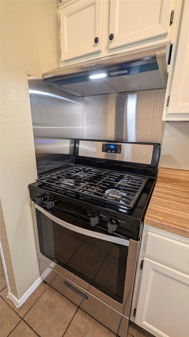 Kitchen with stainless steel range with gas cookt