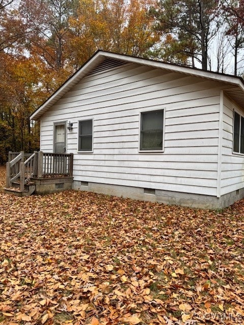 View of side of home with a deck