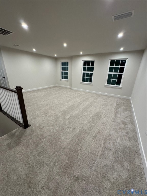 Below grade area with carpet flooring and recessed lighting