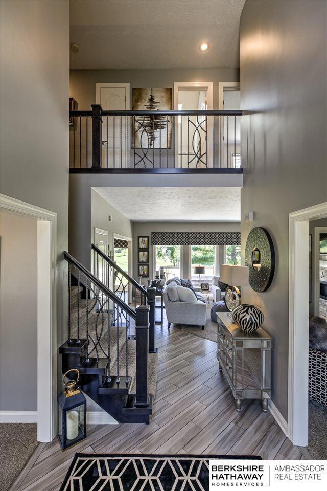 Check out this view as you enter the house.  The gorgeous tile, large windows in back of house for your view of the golf course, and how about the wrought iron spindles on the stairs.  Pure class!