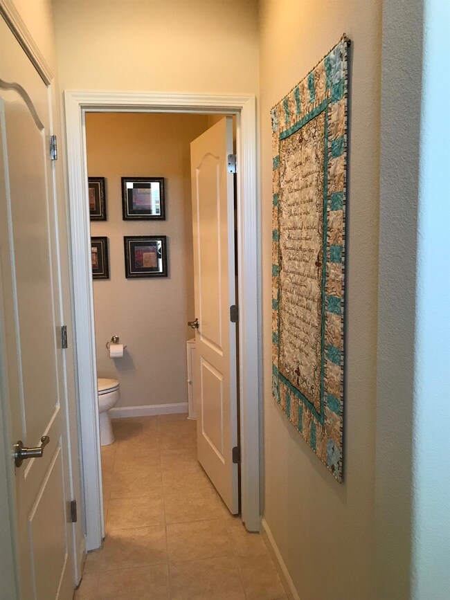 Downstairs includes a powder room half bath. Tile 