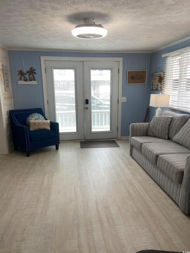 Living room with french doors, hardwood / wood-sty