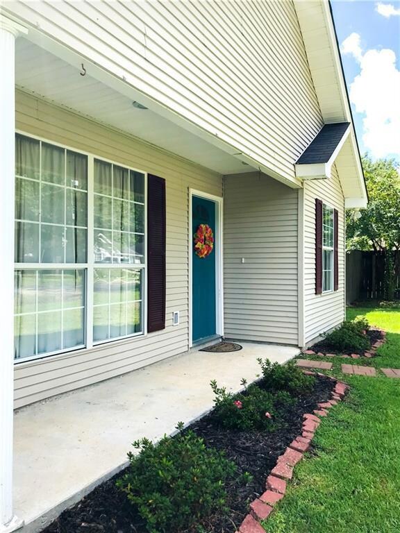 Cute little porch with pretty landscaping
