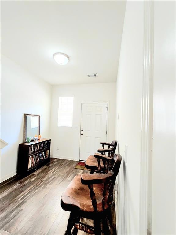 Living area featuring visible vents, baseboards, a