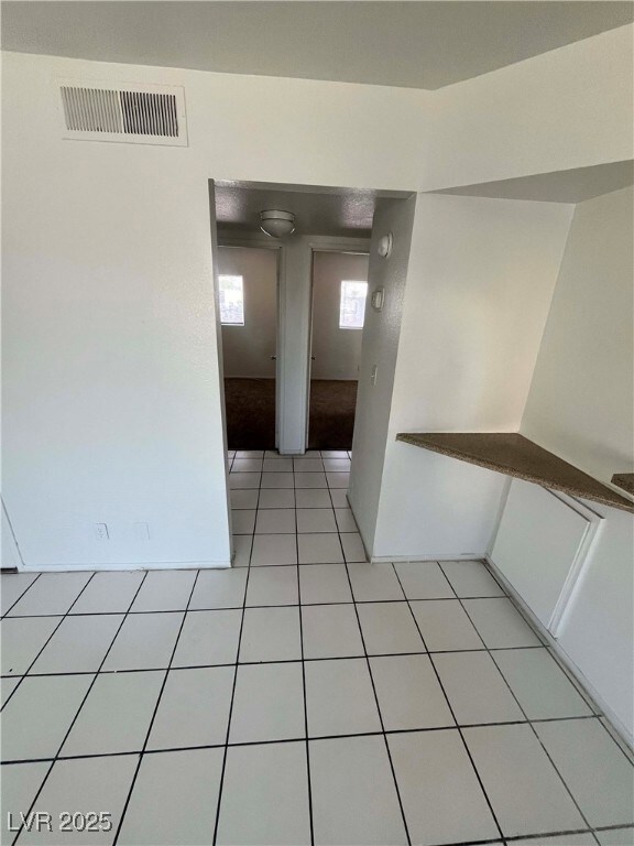 Unfurnished room featuring light tile patterned fl