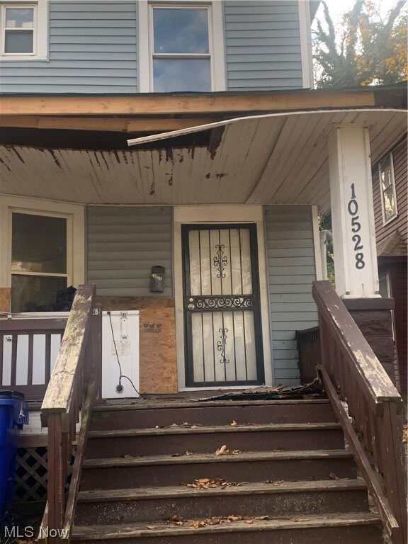 View of exterior entry with a porch