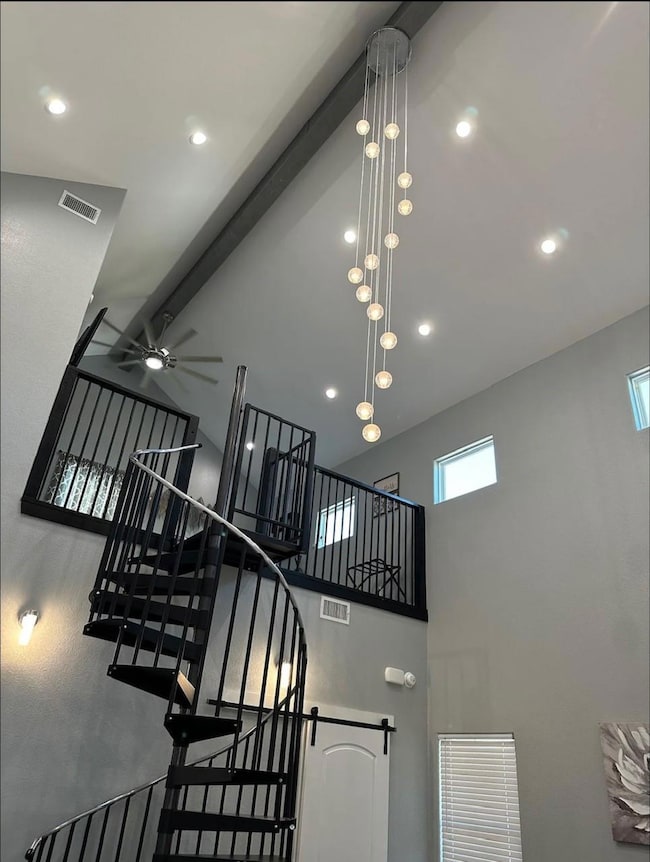 Unit AStairs with ceiling fan, high vaulted ceilin