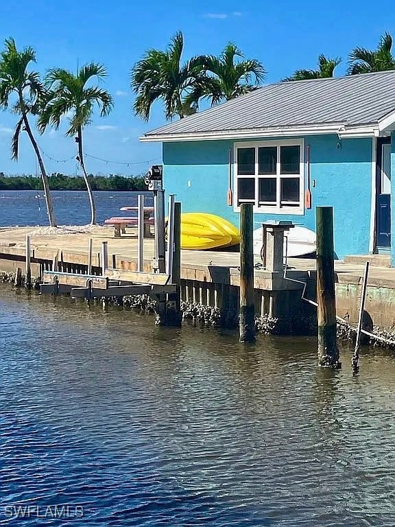 View of dock featuring boat lift and a water view