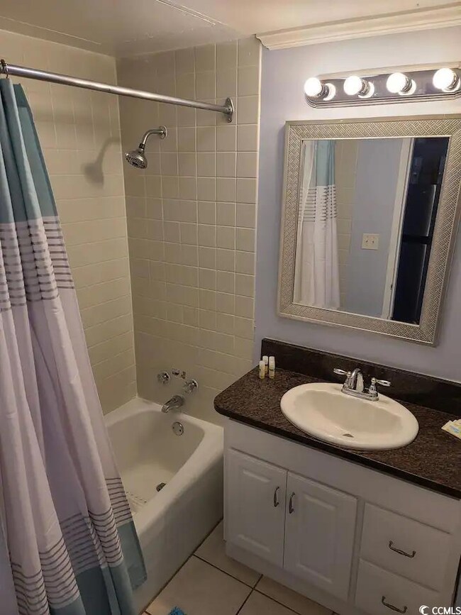 Bathroom featuring vanity, tile patterned flooring