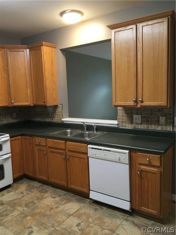 View of kitchen with dishwasher and window into living room.