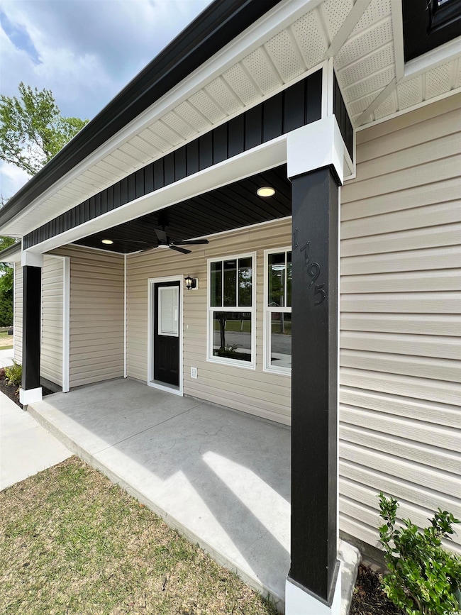 Property entrance with a ceiling fan and a patio a